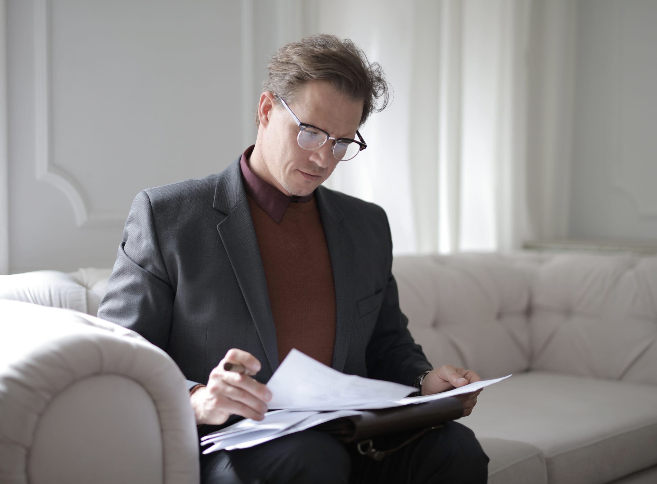 This picture demonstrates a man reviewing his life insurance policy.